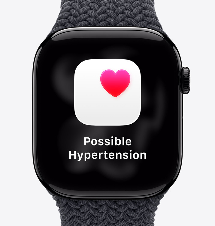 Apple Watch Series 11, Aluminiumgehäuse, Farbe poliertes Diamantschwarz, Mitteilung: Möglicher Bluthochdruck, pinkes Herz in weissem Feld, rechte Seitenansicht, Digital Crown, Sportarmband, Farbe Schwarz