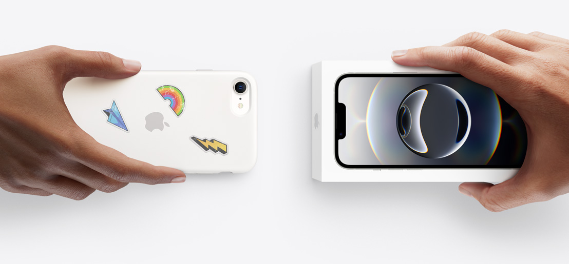 Hands exchanging trade-in iPhone 16e with Silicon cover, stickers on back exterior, for new iPhone 17 in the box.